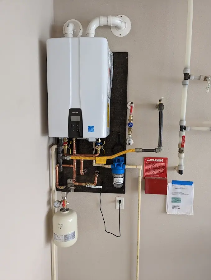 Professional plumber installing copper piping in a Hanover home